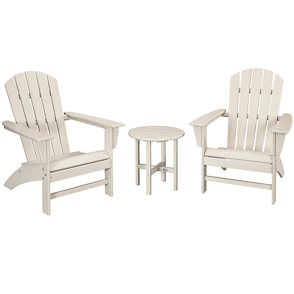 A group of three white POLYWOOD Nautical Adirondack chairs and a round table.