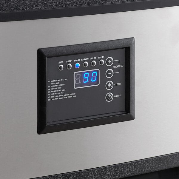 A black and silver rectangular control panel with a digital display.