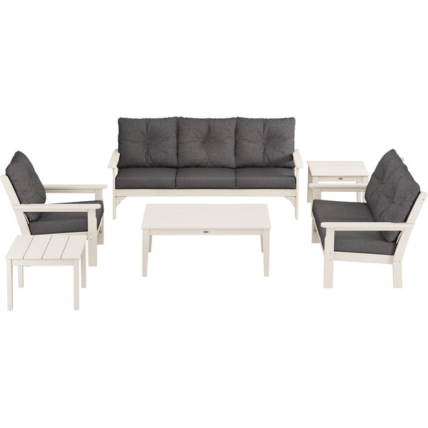 A white and grey POLYWOOD outdoor patio set with chairs and a table.