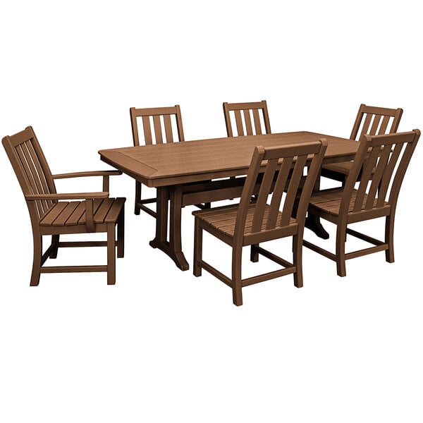 A POLYWOOD teak dining table with chairs on an outdoor patio.