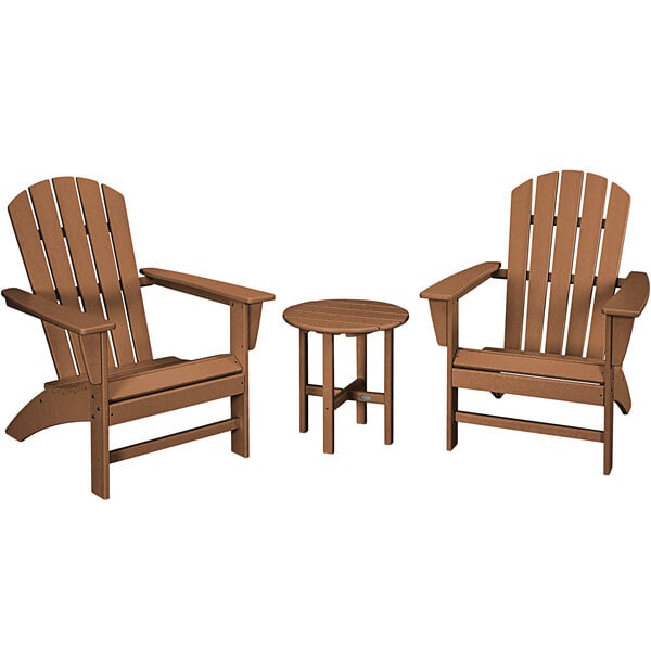 A round wooden table with three POLYWOOD Nautical Adirondack chairs on an outdoor patio.
