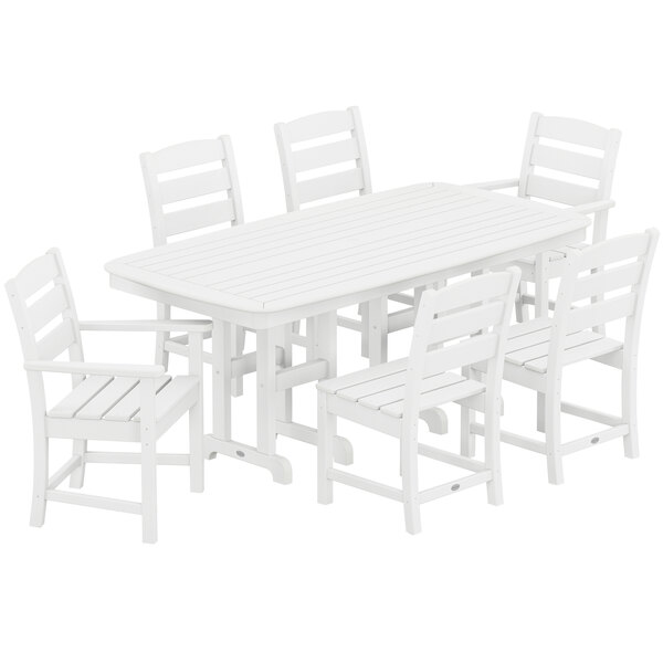 A POLYWOOD white dining table with six white chairs.