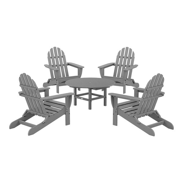 A round table with grey POLYWOOD Adirondack chairs.