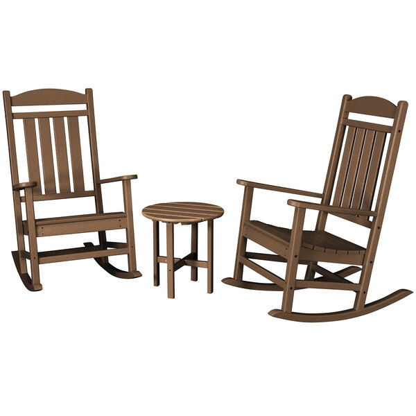 A brown POLYWOOD round table with legs and 2 rocking chairs.