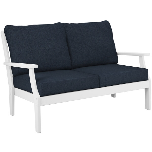 A white POLYWOOD loveseat with blue cushions.