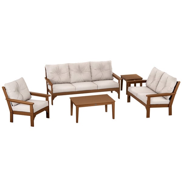 A POLYWOOD teak and dune burlap deep seating set with a table, settee, and chair.