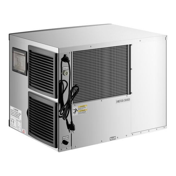 A metallic, box-shaped appliance with vented panels, a power cord, and a grated section on one side.