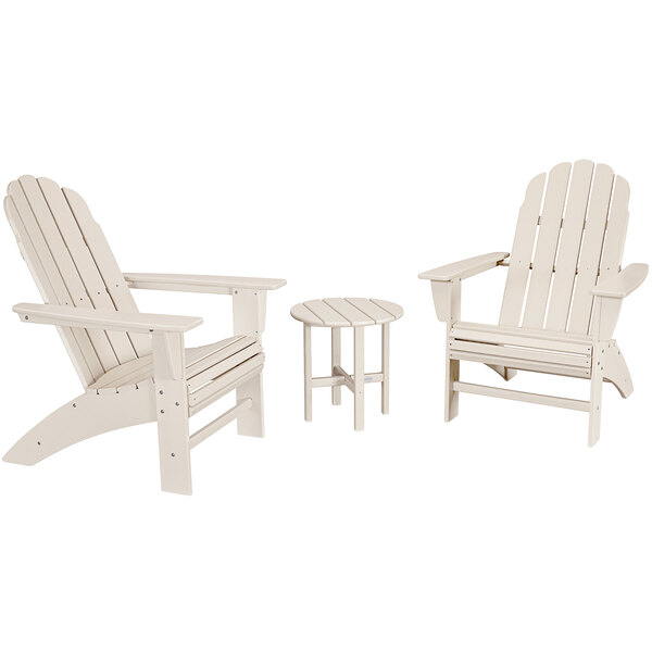 A group of white chairs and a small round table.