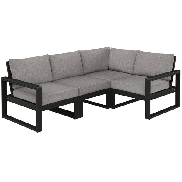 A black and grey POLYWOOD sectional couch with cushions.