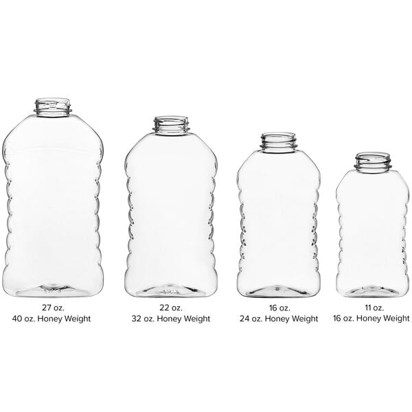 A group of clear Ribbed Hourglass PET Honey Bottles with black lids.
