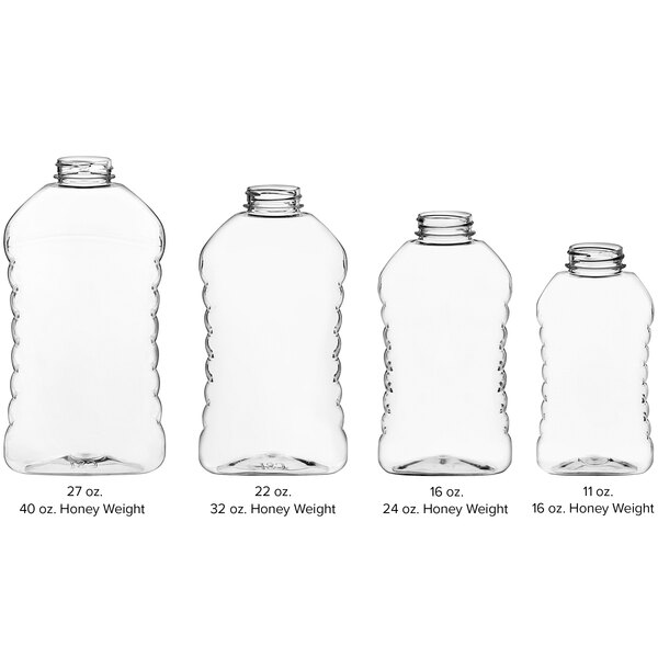 A group of clear plastic ribbed hourglass honey bottles with black lids.