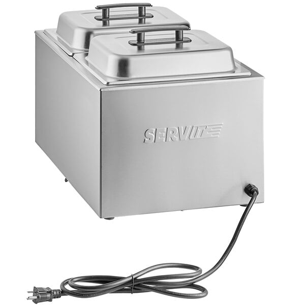 A silver rectangular ServIt electric countertop food cooker/warmer with two pans and two covers, and a cord.