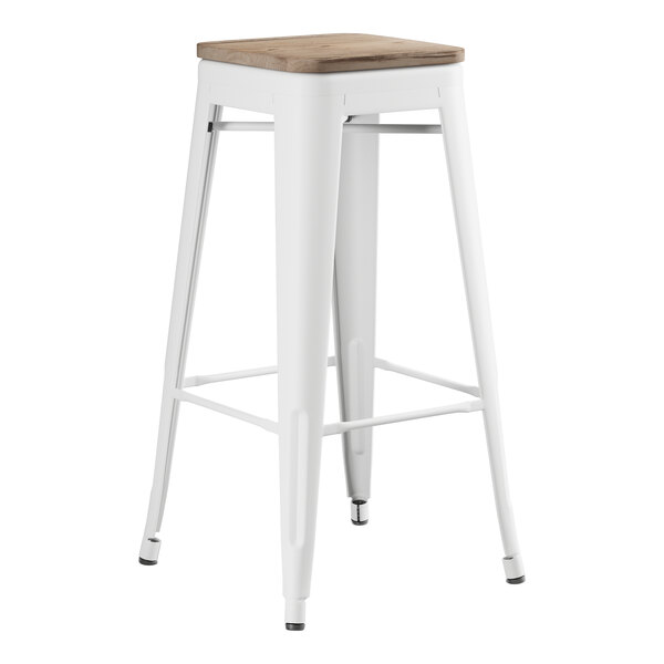 A white Lancaster Table & Seating barstool with a gray wood seat.