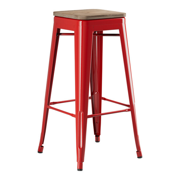 A Lancaster Table & Seating red metal barstool with a gray wood seat.