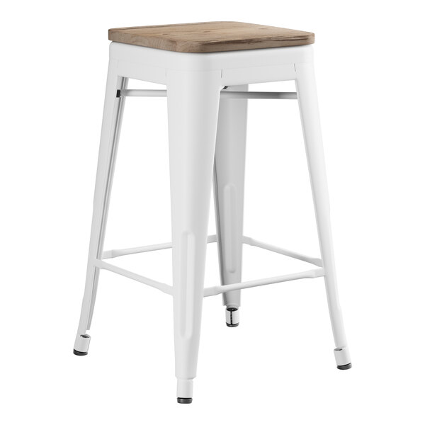 A white Lancaster Table & Seating backless counter height stool with a gray wood seat.