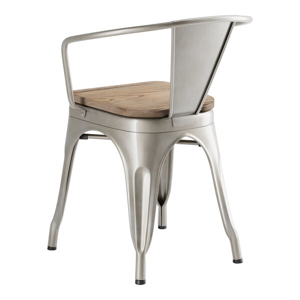 A Lancaster Table & Seating metal arm chair with a gray wood seat.