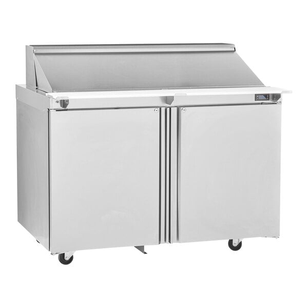 A silver Delfield refrigerator with a white top on wheels.