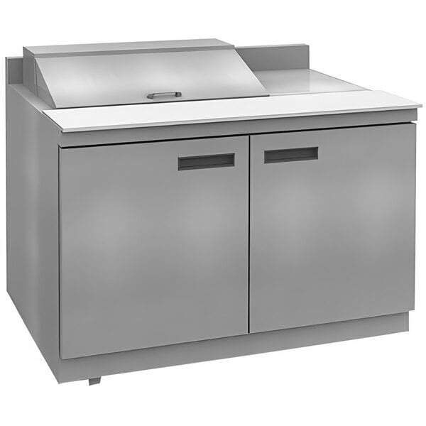 A stainless steel Delfield refrigerated sandwich prep table with 4 drawers.