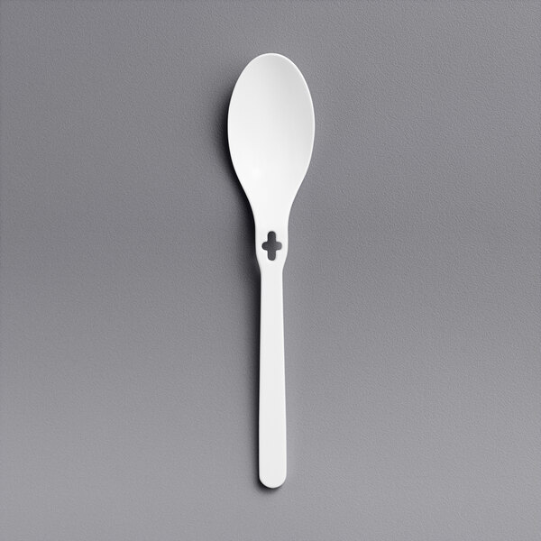 A white plastic spoon with a cross on it.