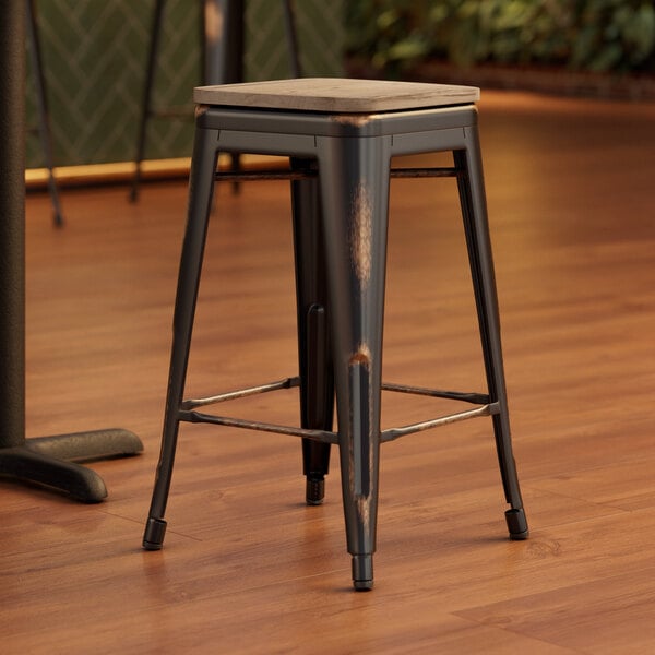 A Lancaster Table & Seating backless counter height stool with a gray wood seat and metal legs.