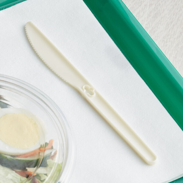 A plastic tray with a WeGo Natural Compostable CPLA knife dispenser refill.