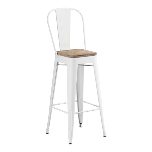 A white Lancaster Table & Seating barstool with a gray wood seat.
