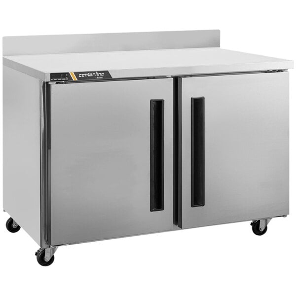 A silver Traulsen worktop freezer with two right hinged doors on a counter.
