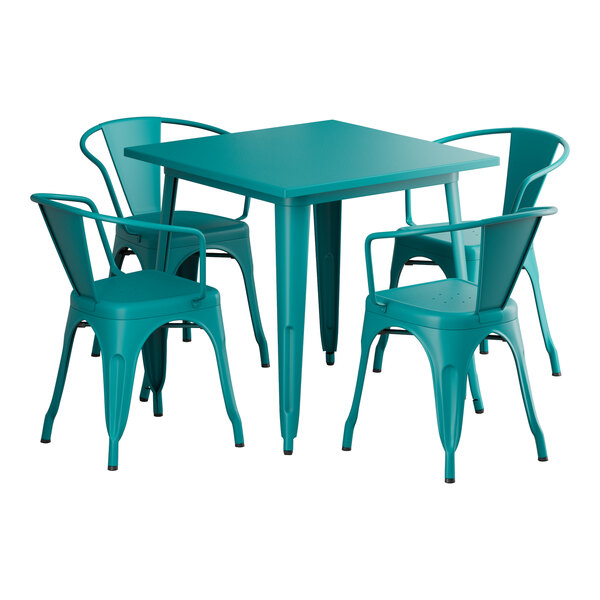 A teal Lancaster Table & Seating outdoor table with four chairs around it.