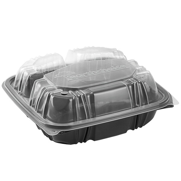 A Pactiv Earthchoice plastic container with clear lids and three compartments.