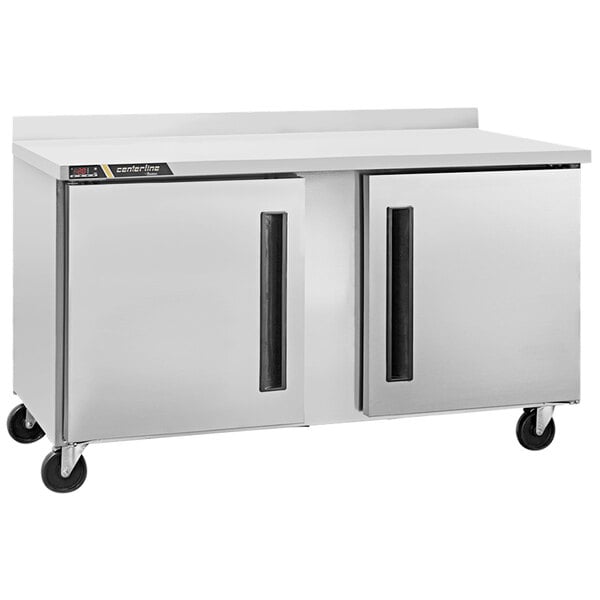 A Traulsen stainless steel compact worktop freezer on wheels.