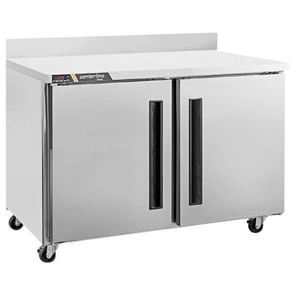 A Traulsen Centerline worktop refrigerator with two doors on wheels.
