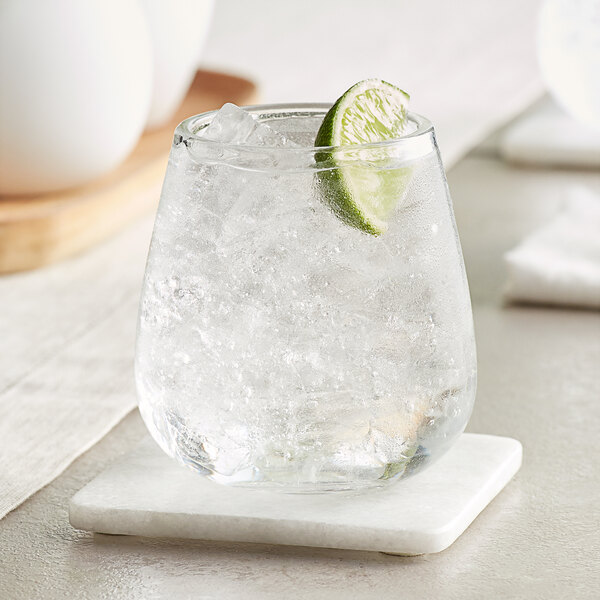 An Acopa stemless wine glass with ice and a lime slice.