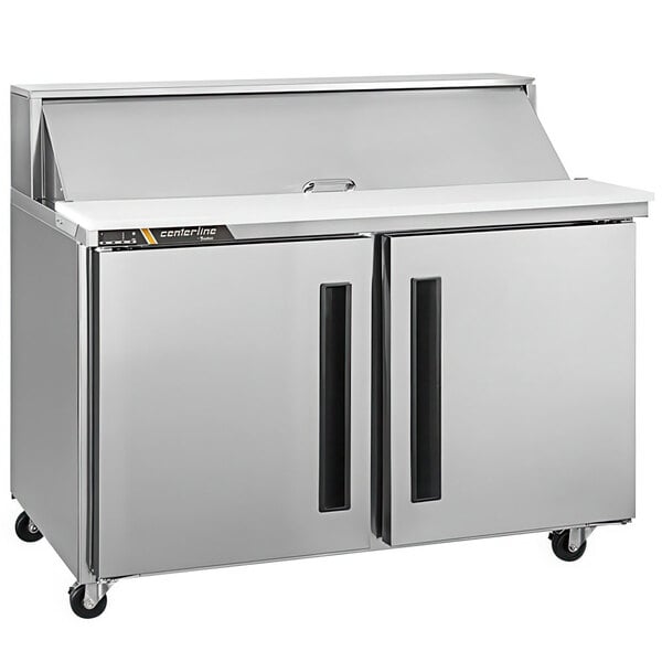 A silver Traulsen refrigerator with two right hinged doors on a refrigerated counter.