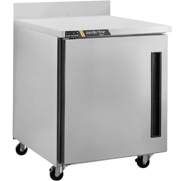 A silver Traulsen worktop refrigerator with a left hinged door on wheels.