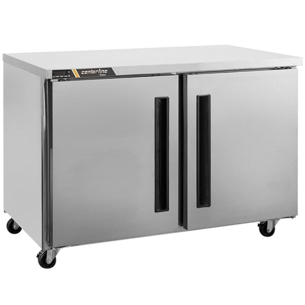 A silver Traulsen undercounter freezer with two doors.