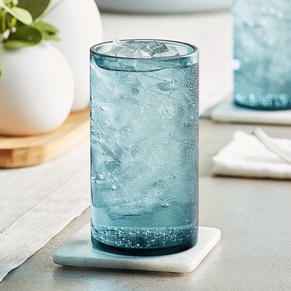 close-up of a white vase and a blue glass
