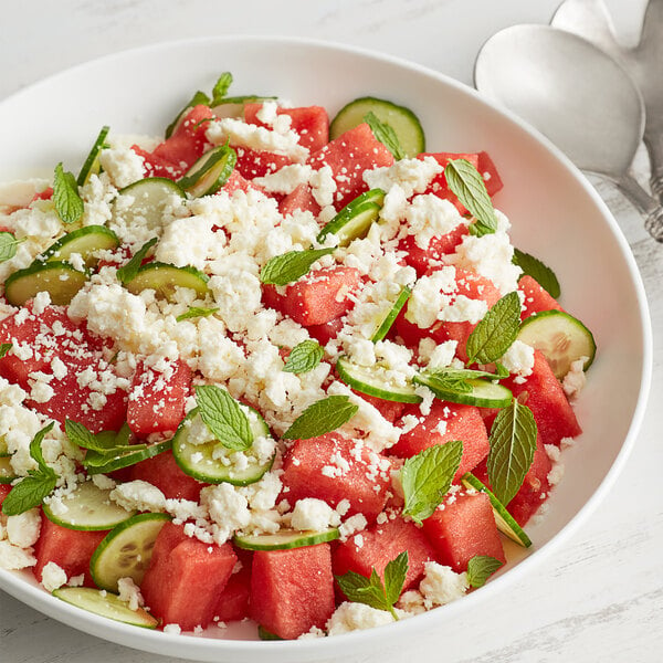 A bowl of watermelon salad with cucumbers and V&V Supremo Queso Fresco cheese.