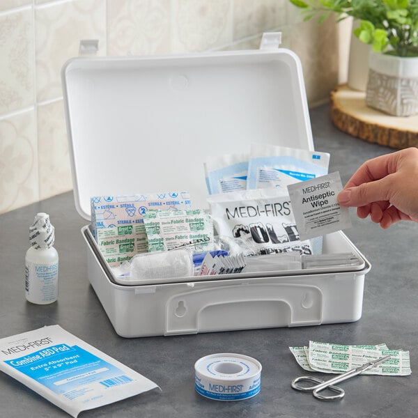 A white plastic first aid kit containing various medical supplies such as bandages, antiseptic wipes, and tape, suitable for up to 25 people.