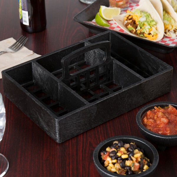 A black HS Inc. condiment organizer with salsa on a table.