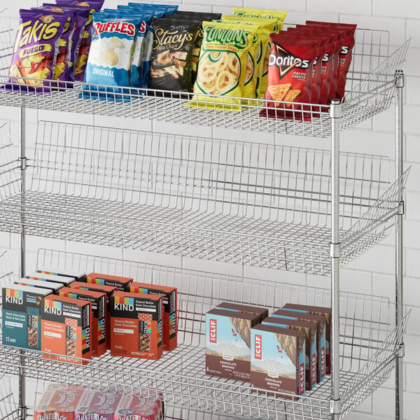 A Regency metal storage display shelf with snacks on it.