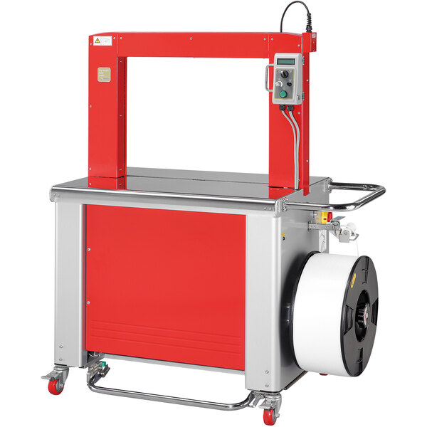 A red and silver PAC Strapping automatic bottom seal strapping machine with a roll of paper.