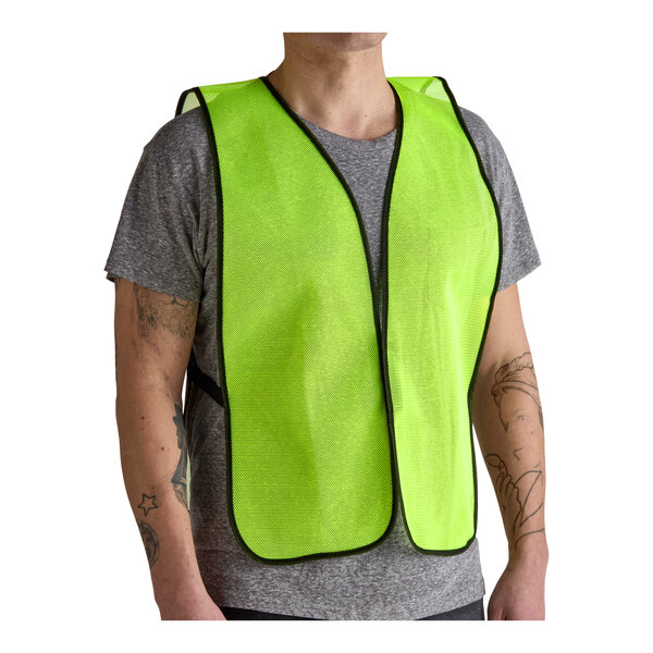 A lime high visibility mesh safety vest worn over a gray t-shirt.