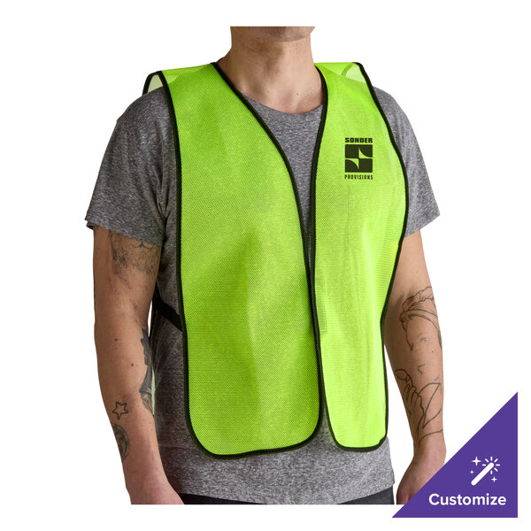 A lime green high visibility mesh safety vest with black trim, worn over a gray t-shirt.