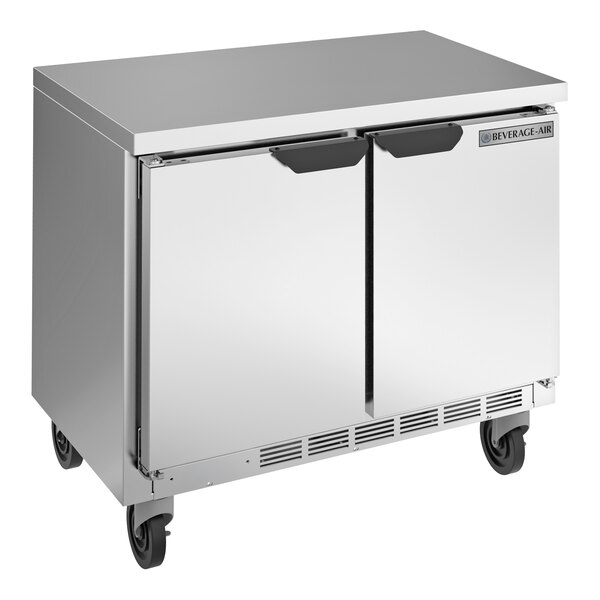 A silver stainless steel Beverage-Air undercounter refrigerator with two doors on wheels.