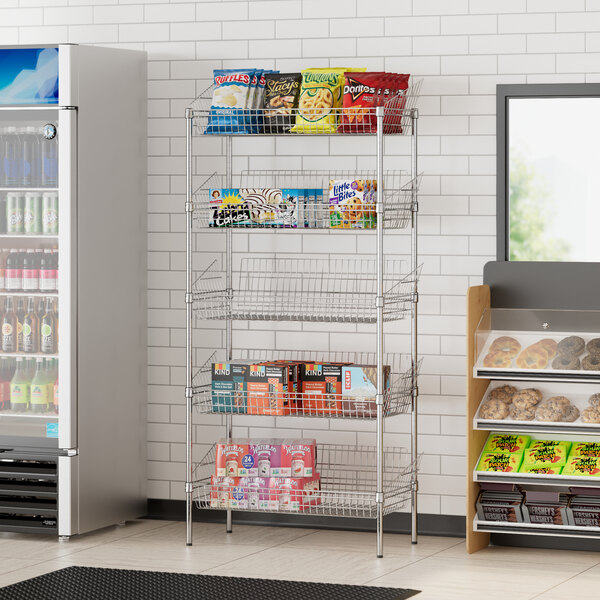 A Regency chrome storage rack with baskets holding snacks and beverages in a convenience store.