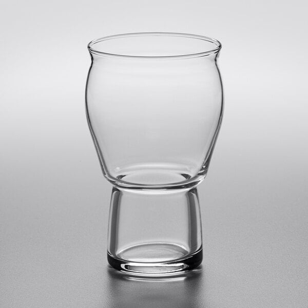 A close-up of a Rastal Craft Master Grand beer glass with a small rim on a white surface.