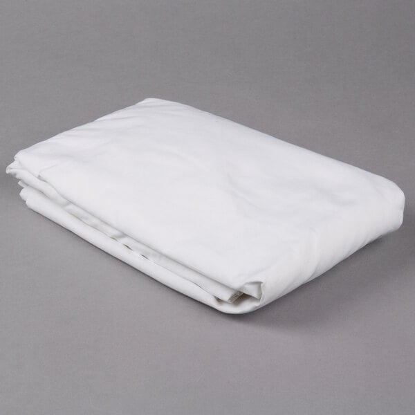 A folded white Oxford Superblend microfiber fitted sheet on a gray surface.