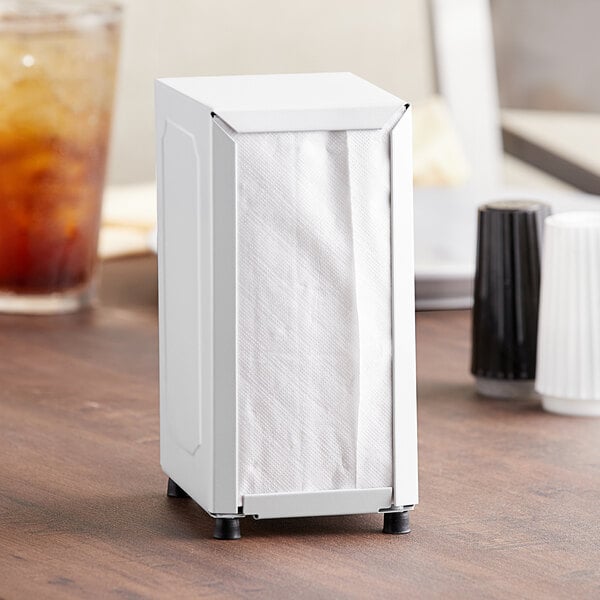 A white Choice tabletop napkin dispenser on a table.