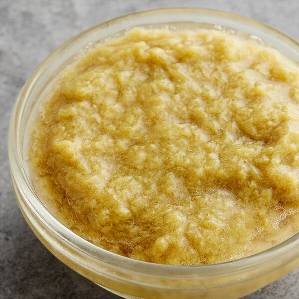 A glass bowl filled with Les Vergers Boiron rhubarb 100% fruit puree.