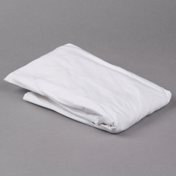 A folded white Oxford Superblend microfiber fitted sheet on a gray surface.